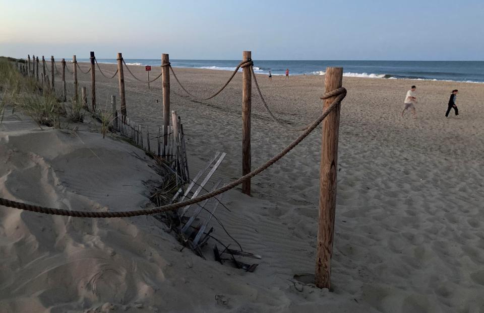 People stroll the nearly deserted beach at Fenwick Island State Park after sunset, Saturday, Sept. 2, 2023 during the unofficial end to summer, Labor Day Weekend.