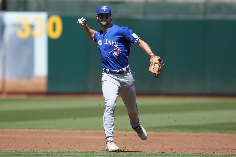 Toronto Blue Jays shortstop Ernie Clement throws out Oakland Athletics' Shea Langeliers at first base during the second inning of a baseball game in Oakland, Calif., Monday, Sept. 4, 2023. (AP Photo/Jeff Chiu)