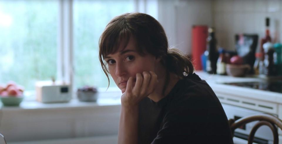 Renate Reinsve sits at a kitchen table