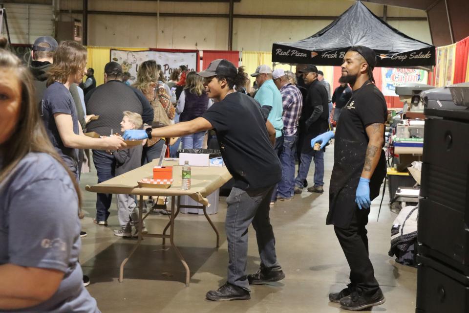 Ronnie Granger II and Ronnie Granger I with Sunday's Kitchen served rattlesnake sausage mac and cheese for the Hope and Healing Place's annual The Big Cheese macaroni and cheese competition at the Rex Baxter Building Friday evening.