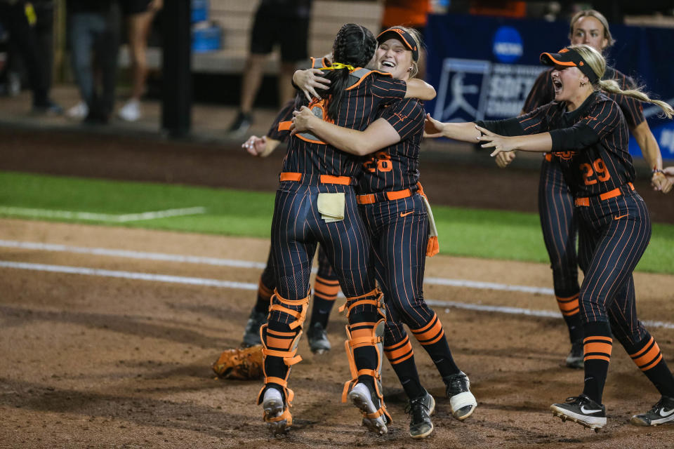 OSU catcher Taylor Tuck hugs pitcher Kelly Maxwell (28) after recording the final out in a 5-1 win against Clemson in Game 2 of the NCAA Stillwater Super Regional on Friday night.