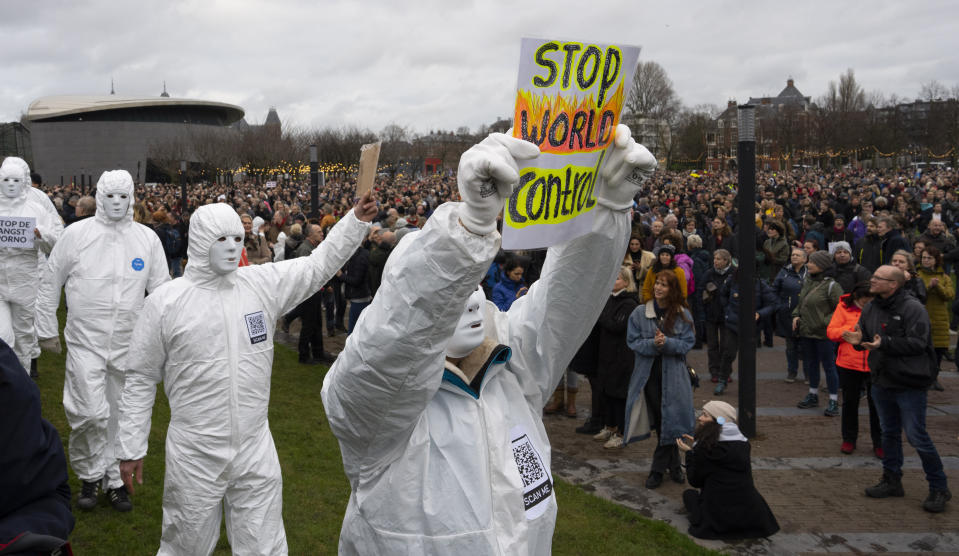 Several thousands of people defied a ban Sunday to gather and protest the Dutch government's coronavirus lockdown measures, in Amsterdam, Netherlands, Sunday, Jan. 2, 2022. The municipality of the Dutch capital banned the protest, saying police had indications some demonstrators could be attending "prepared for violence." (AP Photo/Peter Dejong)