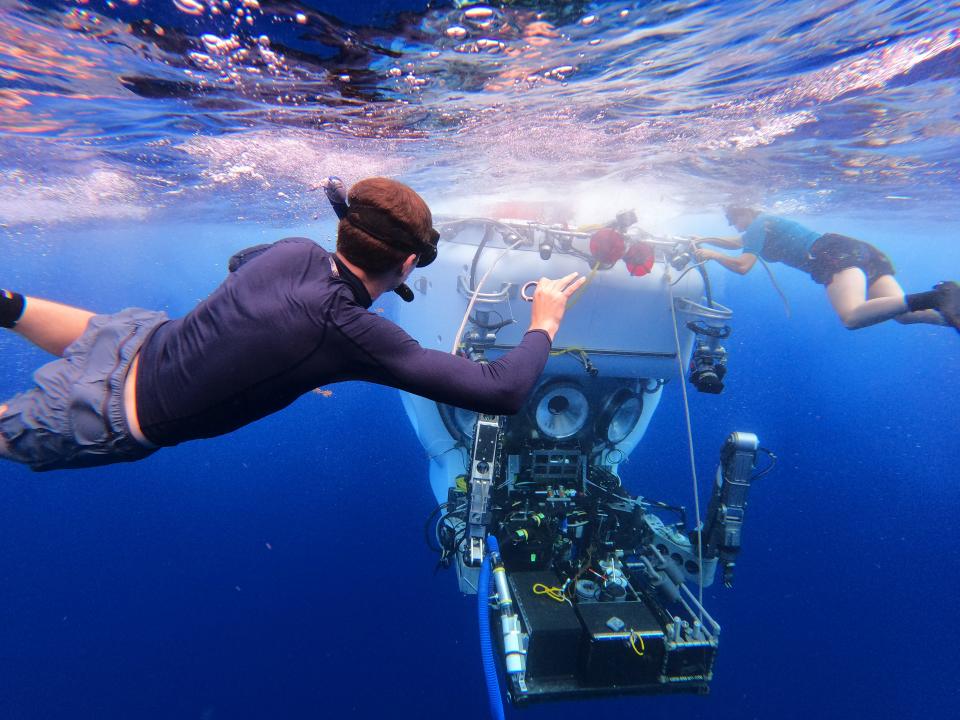 During the summer Woods Hole Oceanographic Institution scientists, joined by fellow scientists from other institutions, tested the research facility's recently upgraded, human-occupied submersible, Alvin, for new depths at the Mid-Cayman Rise and the Puerto Rico Trench. In this photo, divers prepare the 40,000-pound vehicle to be winched back up to the research vehicle Atlantis after a day of exploration.