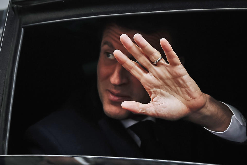 French President Emmanuel Macron waves from his car as he leaves his house after voting in the European elections in Le Touquet, northern France, Sunday May 26, 2019. France is looking at an epic battle between pro-EU centrist President Emmanuel Macron and anti-immigration, far-right flagbearer Marine Le Pen in the European Parliament vote, a duel over Europe's basic values. (AP Photo/Kamil Zihnioglu)