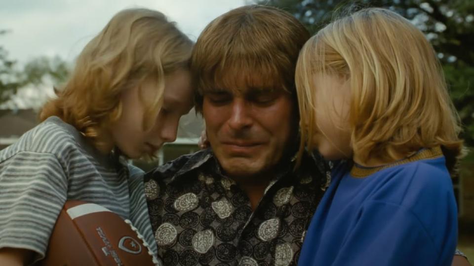 Kevin Von Erich crying and holding his two sons