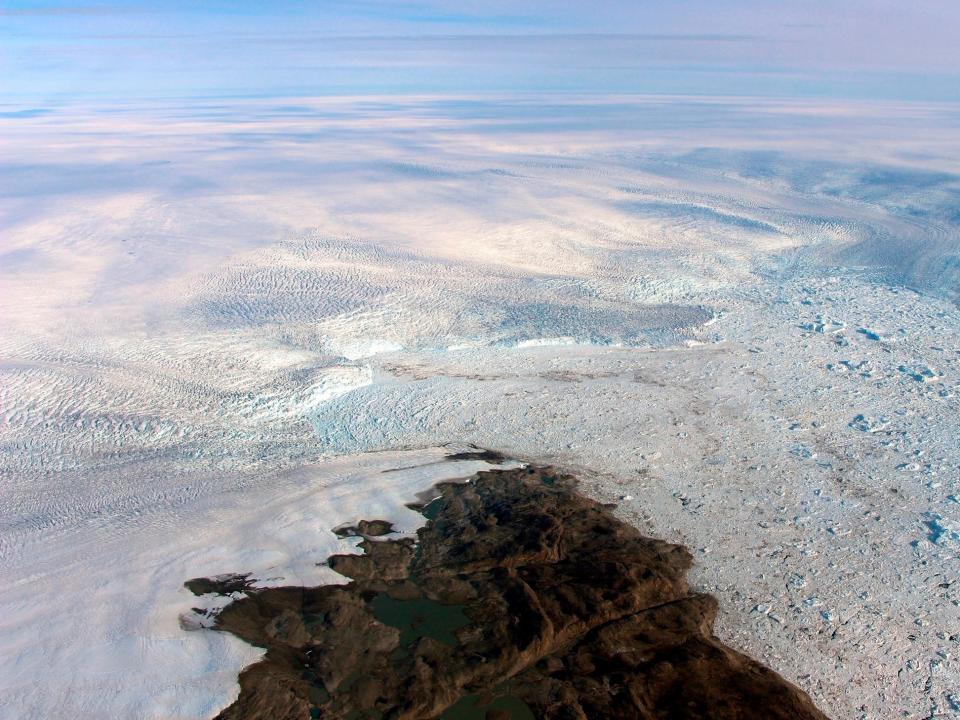 This 2016 photo provided by NASA shows patches of bare land at the Jakobshavn glacier in Greenland. The major Greenland glacier that was one of the fastest shrinking ice and snow masses on Earth is growing again, a new NASA study finds. The Jakobshavn glacier around 2012 was retreating about 1.8 miles (3 kilometers) and thinning nearly 130 feet (almost 40 meters) annually. But the last two years it started growing again at about the same rate, according to a study released on Monday, March 25, 2019, in Nature Geoscience. Study authors and outside scientists think this is temporary.  (NASA via AP)