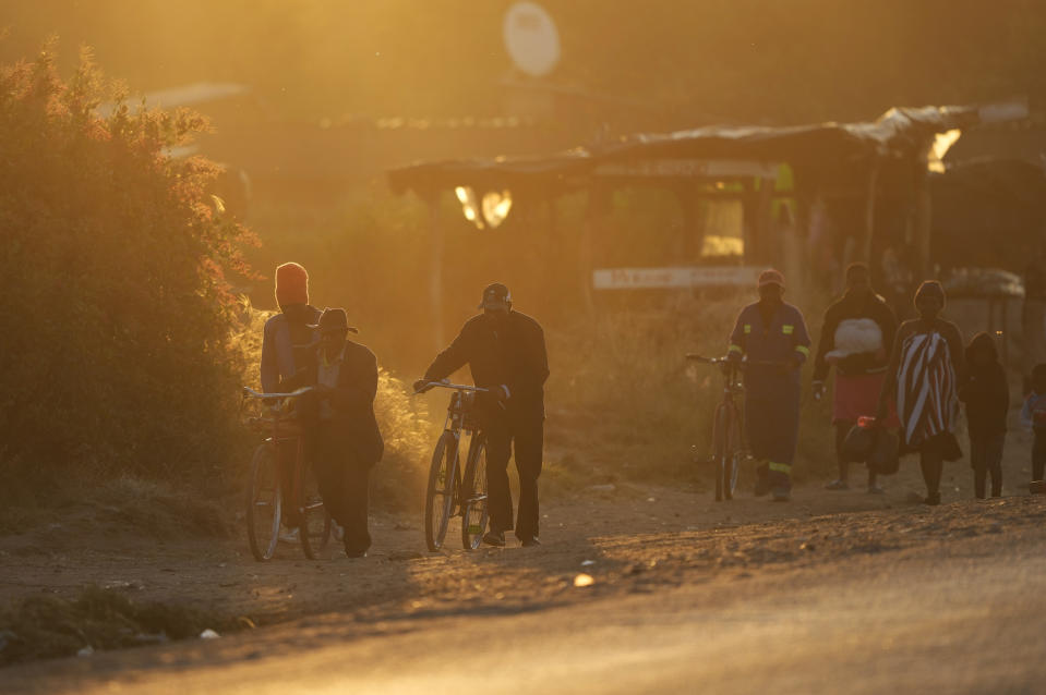 People head home at sunset in Harare, Zimbabwe, Monday, June, 6, 2022. Rampant inflation is making it increasingly difficult for people in Zimbabwe to make ends meet. Since the start of Russia’s war in Ukraine, official statistics show that Zimbabwe’s inflation rate has shot up from 66% to more than 130%. The country's finance minister says the impact of the Ukraine war is heaping problems on the already fragile economy. (AP Photo/Tsvangirayi Mukwazhi)