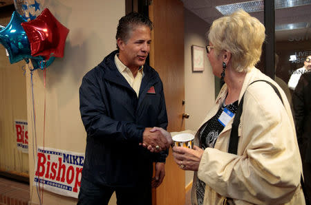 U.S. Rep. Mike Bishop, R-Rochester, who is running for re-election representing Michigan's 8th District, greets a supporter during an event at his campaign office in Rochester Hills, Michigan, U.S., April 12, 2018. Picture taken April 14, 2018. REUTERS/Rebecca Cook