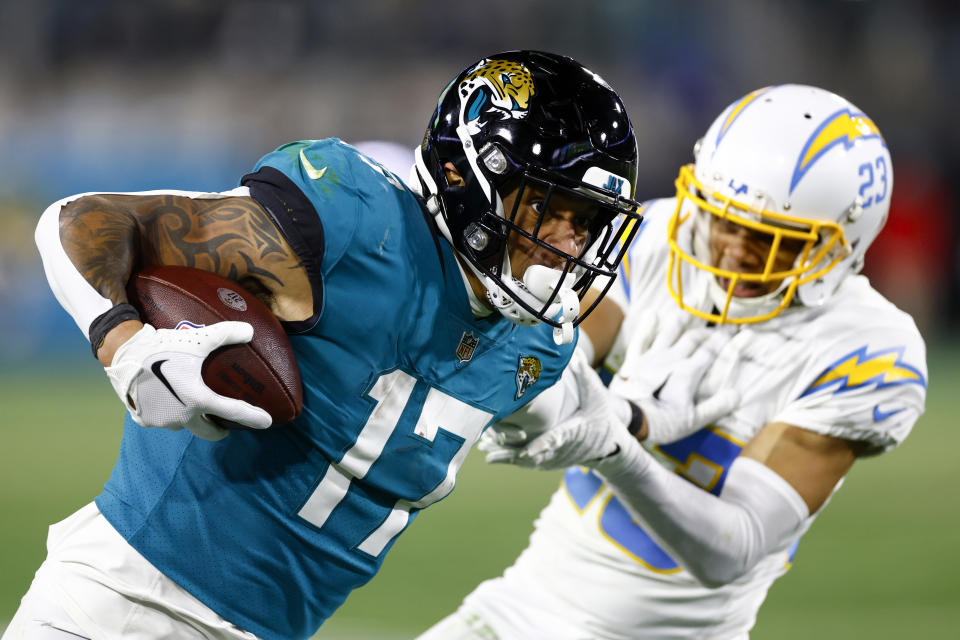 JACKSONVILLE, FLORIDA - JANUARY 14: Evan Engram #17 of the Jacksonville Jaguars carries the ball against the Los Angeles Chargers during the second half of the game in the AFC Wild Card playoff game at TIAA Bank Field on January 14, 2023 in Jacksonville, Florida. (Photo by Douglas P. DeFelice/Getty Images)