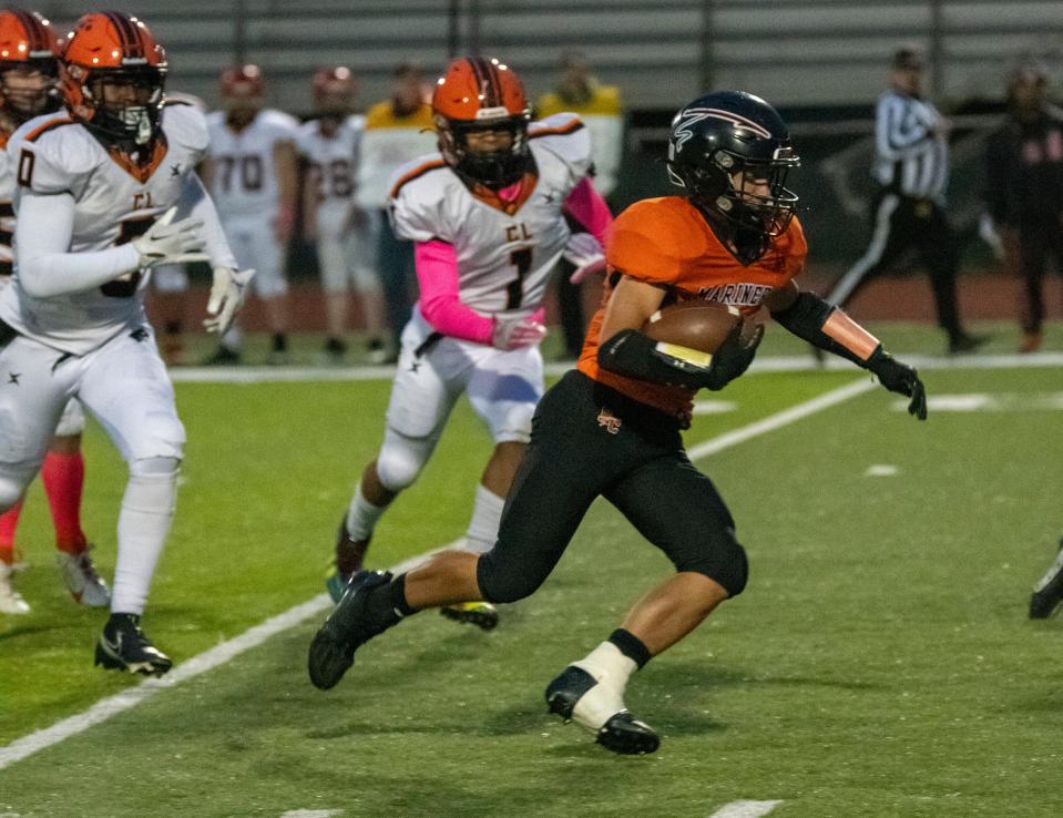 Marine City’s Paul Muscat runs the ball up the field Friday, Oct. 13, 2023, during their football game against Center Line at East China Stadium.