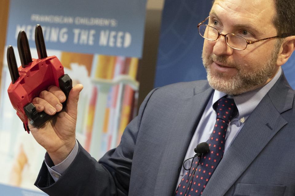 James Swarrtz, director of World Against Toys Causing Harm, talks about the dangers of the Power Rangers Electronic Cheetah Claw during a news conference in Boston, Tuesday, Nov. 19, 2019. (AP Photo/Michael Dwyer)