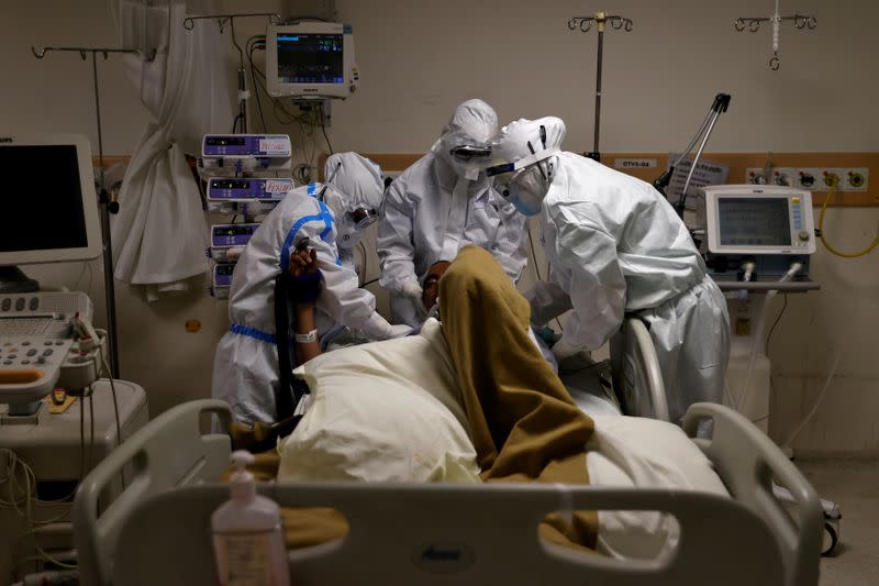 Medical workers treat patients infected with the coronavirus disease (COVID-19) at a hospital in New Delhi