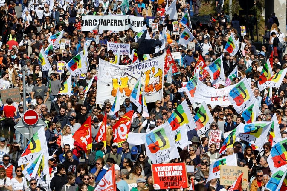 Protesters holds French labour union flags during a demonstration as part of the ninth day of nationwide strikes (REUTERS)