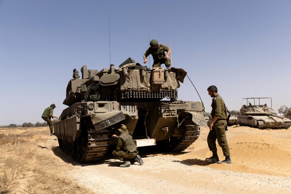 Israeli soldiers organize their equipment and a tank near the border with the Southern Gaza Strip  on 5 May 2024 in Southern Israel, Israel (Getty Images)