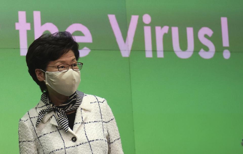 Hong Kong Chief Executive Carrie Lam arrives at a press conference in Hong Kong, Monday, July 13, 2020. Hong Kong on Monday introduced more stringent social-distancing measures, banning public gatherings of more than four and making it compulsory to wear a mask on public transport as the city battles a fresh outbreak of locally-transmitted coronavirus infections. (AP Photo/Vincent Yu)