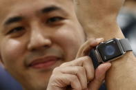 Yuichiro Masui, the first customer to purchase an Apple Watch at an electronics store in Omotasando, poses with his watch in Tokyo April 24, 2015. REUTERS/Thomas Peter