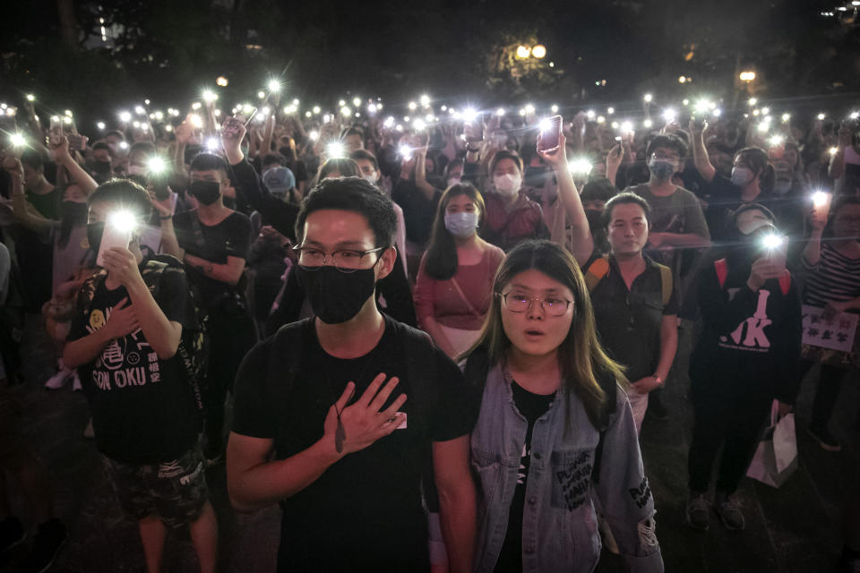FILE - Demonstrators hold their cellphones aloft as they sing "Glory to Hong Kong" during a rally at Chater Garden in Hong Kong on Oct. 26, 2019. A popular Hong Kong protest song was no longer available Wednesday, June 14, 2023, on several major music streaming sites and social media platforms, after the government sought an injunction to ban the tune. (AP Photo/Mark Schiefelbein, File)