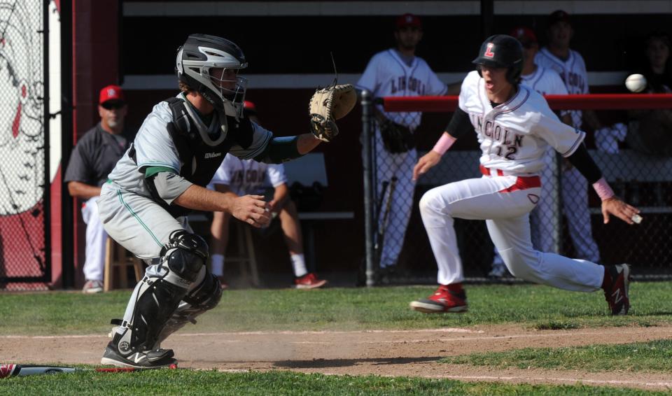 Lincoln's Zachary Morgan beats the throw to home as St. Mary's catcher Tevin Hernandez waits for the ball during a game on May 2, 2016, at Lincoln High School in Stockton.