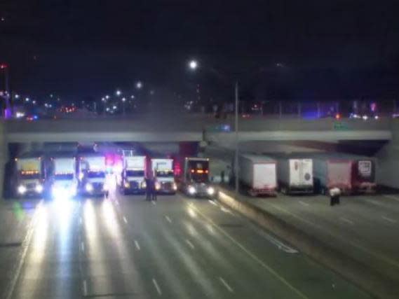 Lorry drivers line up under motorway bridge to stop man jumping to death