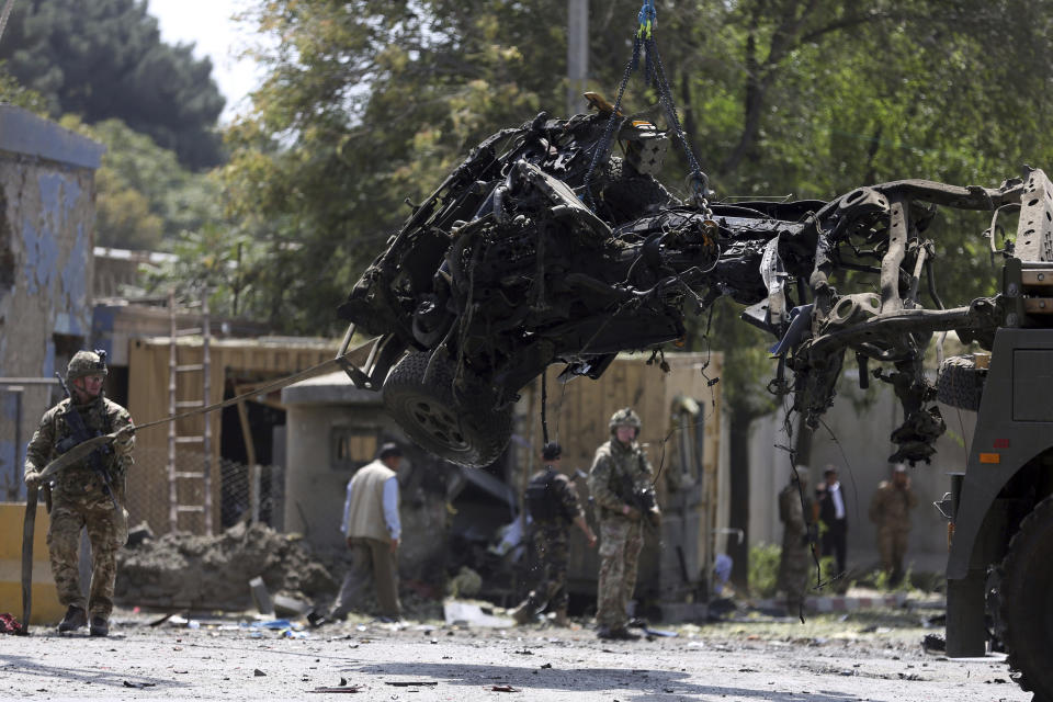 Resolute Support (RS) forces and Afghan security personnel clear debris at the site of a car bomb explosion in Kabul, Afghanistan, Thursday, Sept. 5, 2019. A car bomb rocked the Afghan capital on Thursday and smoke rose from a part of eastern Kabul near a neighborhood housing the U.S. Embassy, the NATO Resolute Support mission and other diplomatic missions. (AP Photo/Rahmat Gul)