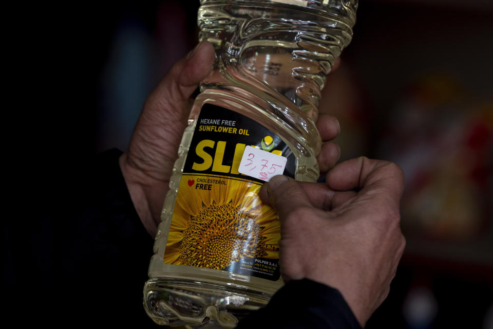 Moheidein Bazazo changes price tags from Lebanese pound to the U.S. dollar in a shop in in Beirut, Lebanon, Wednesday, March 1, 2023. Lebanon began pricing consumer goods in supermarkets in U.S. dollars Wednesday as the value of the Lebanese pound hit new lows. (AP Photo/Hassan Ammar)