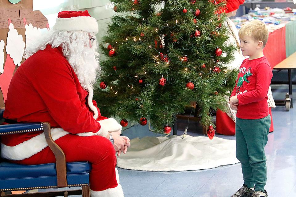 Hudson Farley talks with Santa at the breakfast with Santa at Mapleton Elementary School on Saturday, Dec. 4, 2021. TOM E. PUSKAR/TIMES-GAZETTE.COM