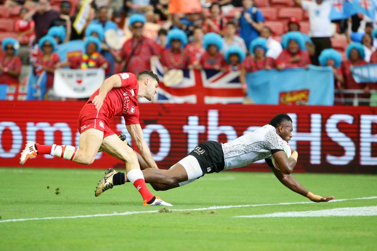 The Fiji rugby sevens team (white jersey) scoring a try against Canada at the HSBC Singapore Rugby Sevens on 13 April, 2019. (PHOTO: HSBC Singapore Rugby Sevens)