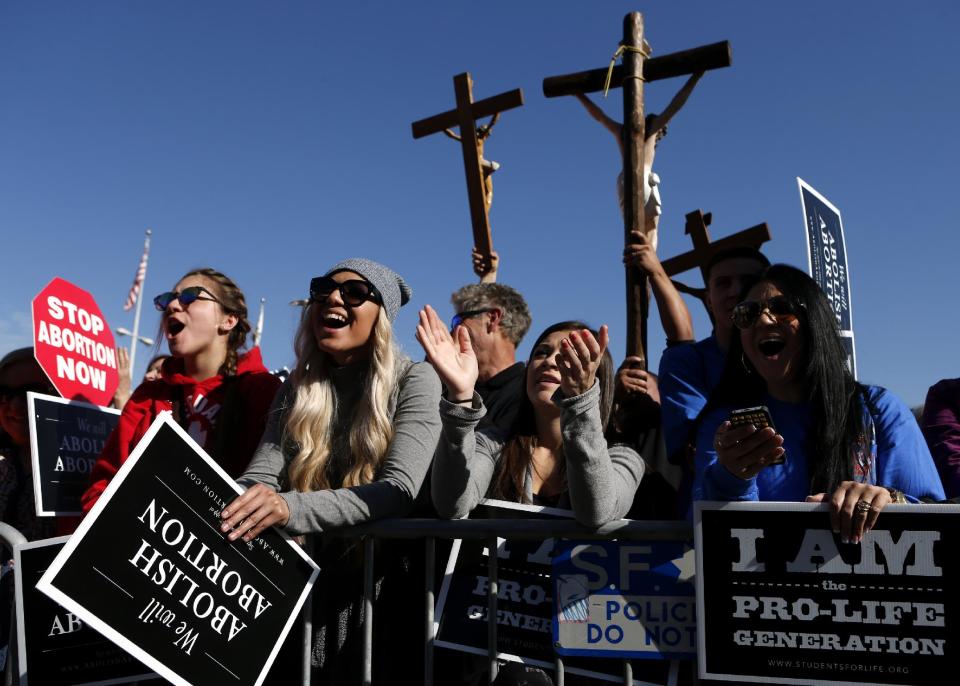 From left, abortion opponents Bianca Magana, Mikaela Magana, Courtney Elium and Bianca E. Magana, gather in San Francisco's Civic Center for the "Walk for Life" rally and march, Saturday, Jan. 25, 2014, in San Francisco. Thousands of abortion opponents marched through downtown San Francisco for the 10th annual "Walk for Life West Coast." The protesters rallied at Civic Center Plaza in front of City Hall before marching down Market Street to Justin Herman Plaza. (AP Photo/Beck Diefenbach)