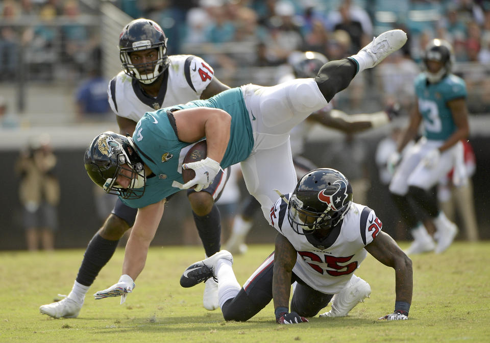 <p>Jacksonville Jaguars running back Tommy Bohanon, center, is stopped by Houston Texans strong safety Kareem Jackson, lower right, and linebacker Zach Cunningham (41) during the second half of an NFL football game, Sunday, Oct. 21, 2018, in Jacksonville, Fla. (AP Photo/Phelan M. Ebenhack) </p>