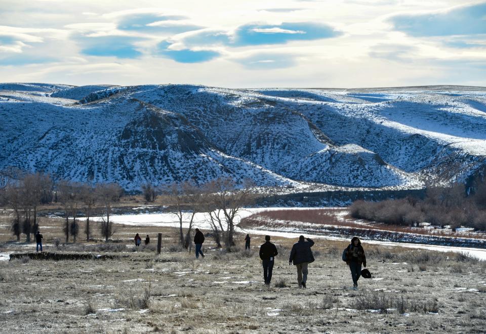People walk down to view the Marias River during the commemoration of the 150th anniversary of the Baker Massacre on Thursday, January 23, 2020.