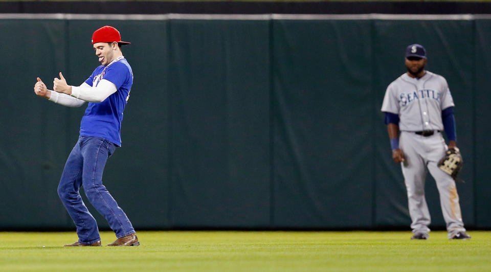 A fan runs on the field as the Seattle Mariners take on the Texas Rangers in the bottom of the seventh inning at Globe Life Park in Arlington on April 16, 2014 in Arlington, Texas. (Photo by Tom Pennington/Getty Images)