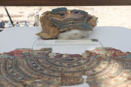 A broken mummy mask is seen inside a glass casing, on display near Egypt's Saqqara necropolis, in Giza Egypt July 14, 2018. REUTERS/Mohamed Abd El Ghany