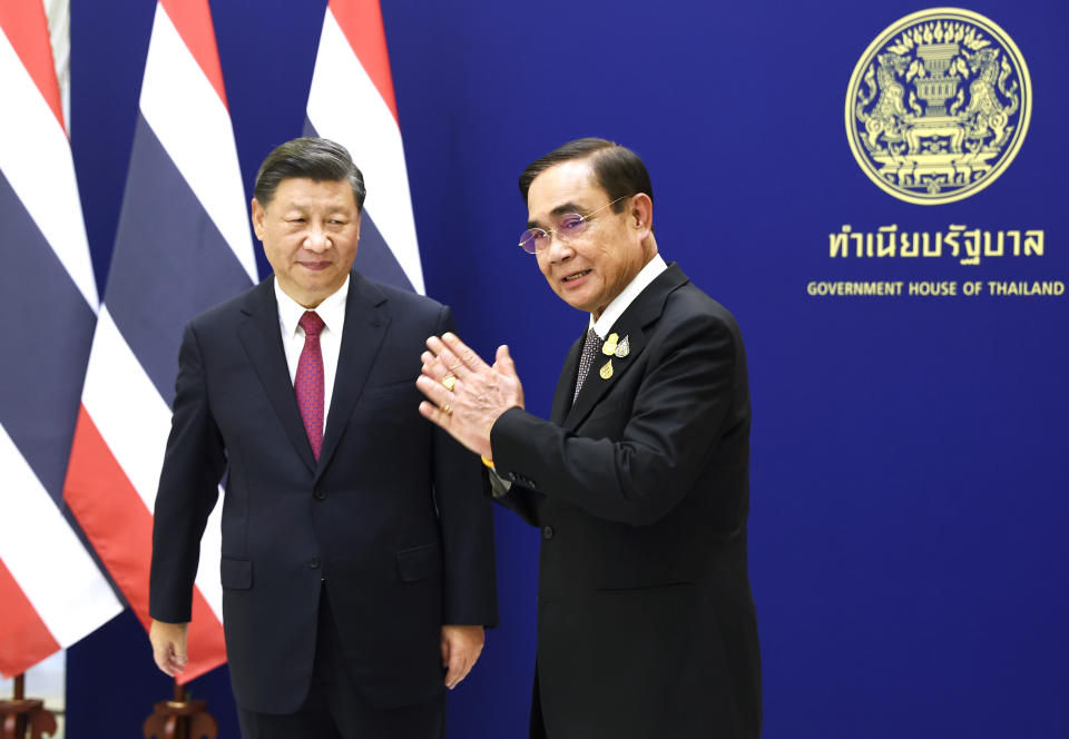 Chinese President Xi Jinping, left, meets with Thailand's Prime Minister Prayuth Chan-ocha, on the sidelines of the Asia-Pacific Economic Cooperation, APEC summit, at the Government House, Saturday, Nov. 19, 2022, in Bangkok, Thailand. (Athit Perawongmetha/Pool Photo via AP)