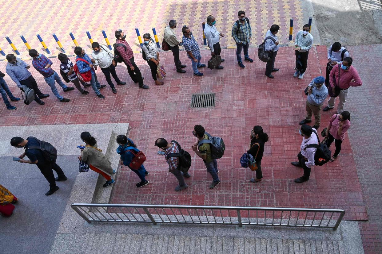 <p>Commuters wait in a queue to enter a metro station following the resumption of services after seven weeks of lockdown imposed as preventive measure against the Covid-19 coronavirus at Vaishali metro station in Ghaziabad</p> (AFP via Getty Images)