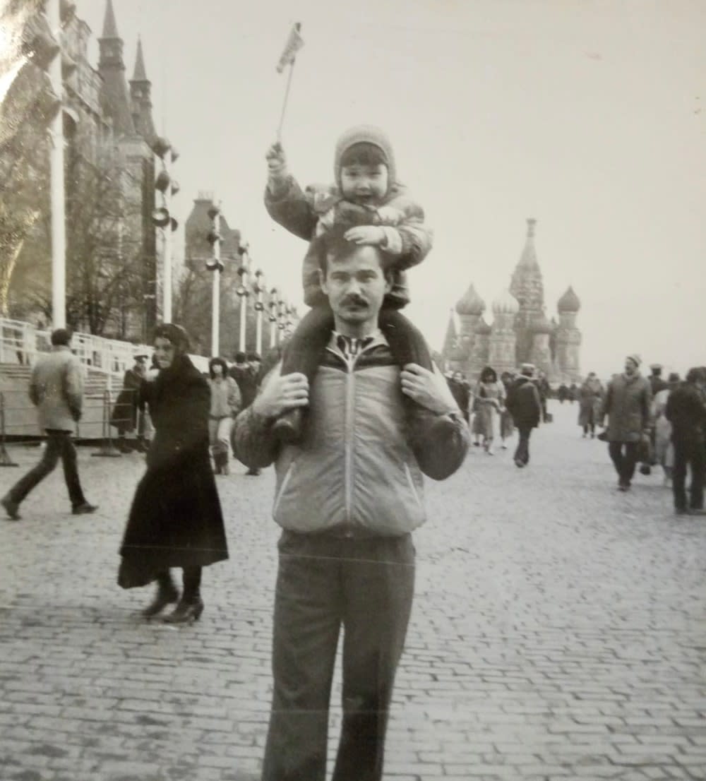 Aliia Roza as a child on the shoulders of her father