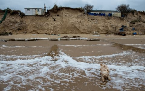 Tidal surges in 2013 saw three homes in the area fall into the sea and a further seven homes badly damaged. - Credit: Chris J Ratcliffe/Getty 