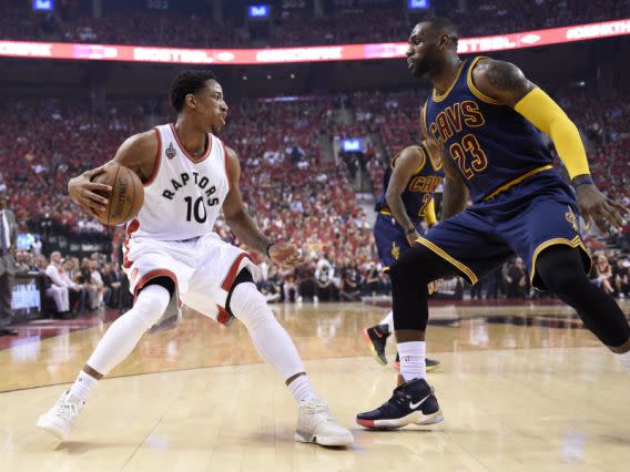 Toronto Raptors guard DeMar DeRozan, left, controls the ball as Cleveland Cavaliers forward LeBron James defends during the first half of Game 6 of the NBA basketball Eastern Conference finals, Friday, May 27, 2016, in Toronto. (Frank Gunn/The Canadian Press via AP)