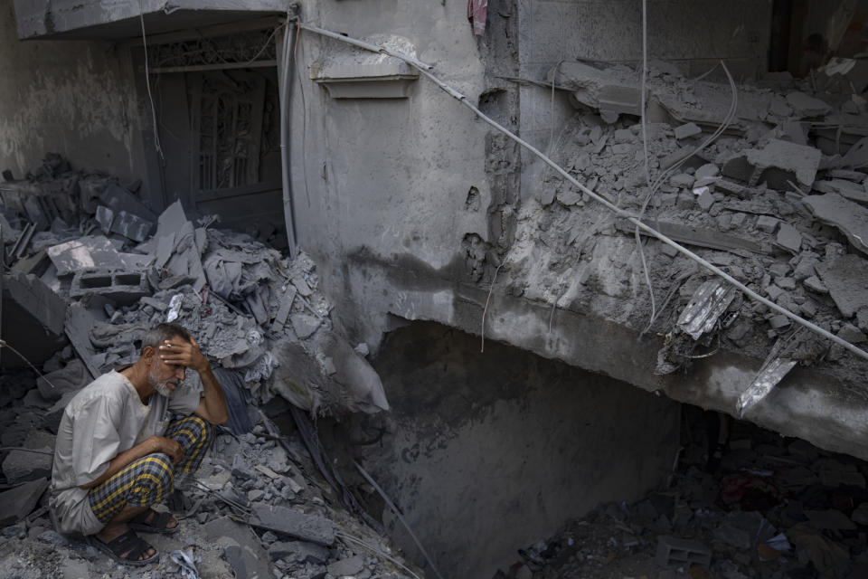 A man sits outside his building which was destroyed during Israeli bombardment in Rafah refugee camp in Gaza Strip on Tuesday, Oct. 17, 2023. (AP Photo/Fatima Shbair)