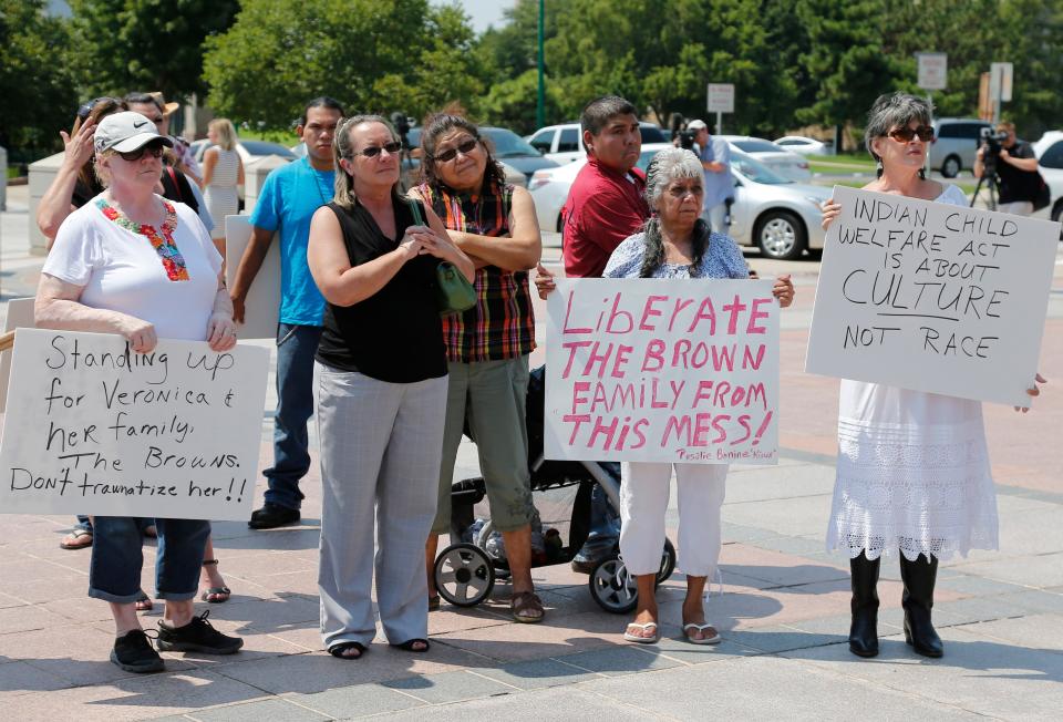 Participants listen during a rally in support of three-year-old baby Veronica, Veronica's biological father, Dusten Brown, and the Indian Child Welfare Act, in Oklahoma City, Monday, Aug. 19, 2013. Brown is trying to maintain custody of the girl who was given up for adoption by her birth mother to Matt and Melanie Capobianco of South Carolina.