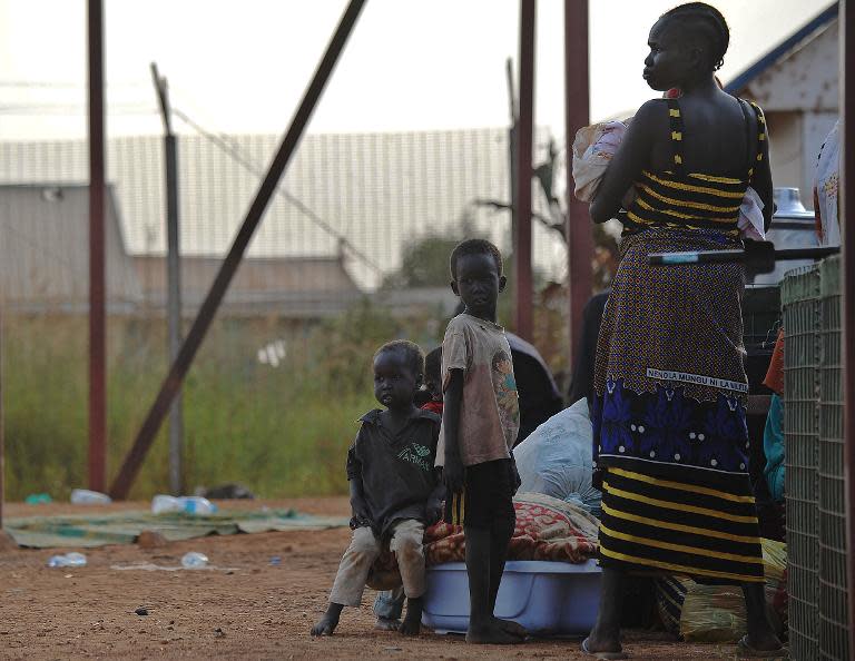 A young South Sudanese mother with her children at the gates of the UNMISS compound in Juba on December 22, 2013