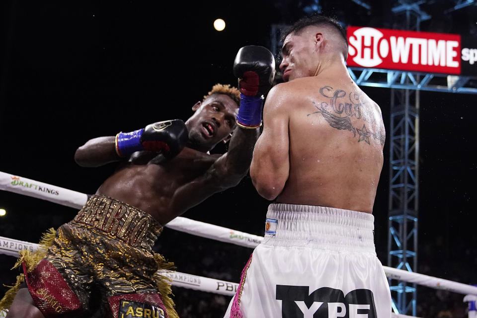 Jermell Charlo, left, follows through on a left to Brian Castano during a super welterweight boxing title bout Saturday, May 14, 2022, in Carson, Calif. (AP Photo/Marcio Jose Sanchez)