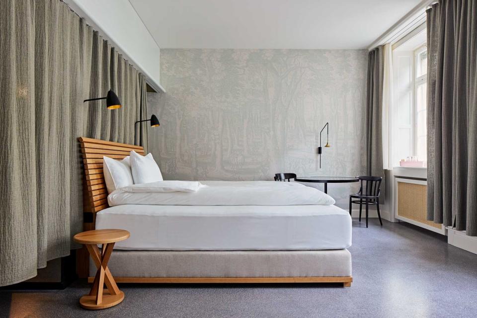 A grey-and-wood guest room in a hotel in Switzerland