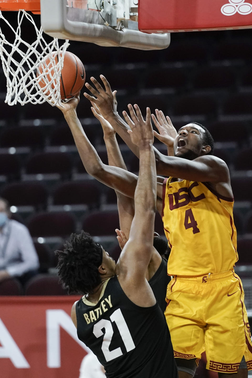Southern California's Evan Mobley, right, shoots over Colorado's Evan Battey during the second half of an NCAA college basketball game, Thursday, Dec. 31, 2020, in Los Angeles. Colorado won 72-62. (AP Photo/Jae C. Hong)
