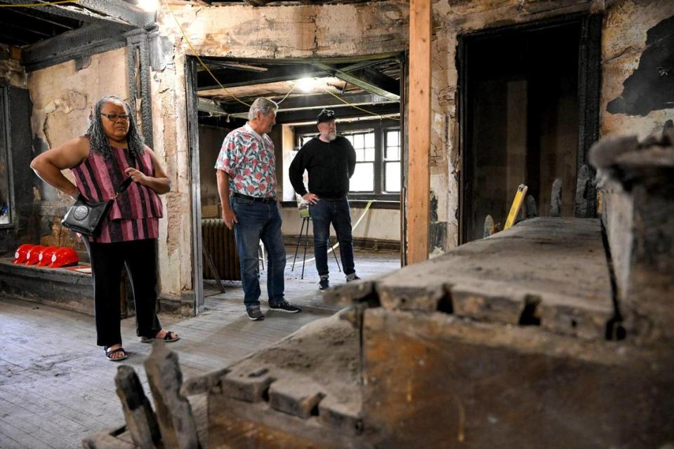 Members of the Pitch Perfect team, including Marquita Brockman Taylor, from left, Gary Abram and Robert Riccardi, toured the fire-ravaged Satchel Paige house recently. The group is overseeing the renovation of the historic home.