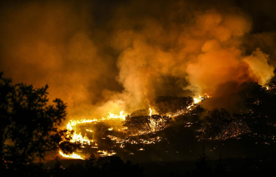 A fire burns on the hill East of Centerville early on the morning of Friday, Aug. 30, 2019. Three homes were destroyed and anther eight were impacted with fire damage. An additional 400 homes have been evacuated in the Centerville area. (Colter Peterson/The Deseret News via AP)