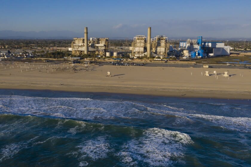 HUNTINGTON BEACH, CA - February 17: A view of the older AES Huntington Beach Power Station at left, and new one at right, and is the proposed site of the Poseidon Desalination Plant, which would draw ocean water through an existing intake pipe at Wednesday, Feb. 17, 2021 in Huntington Beach, CA. (Allen J. Schaben / Los Angeles Times)