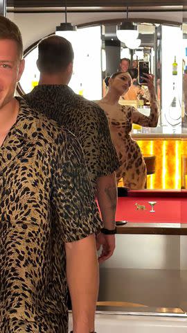 <p>Olivia Culpo/Instagram</p> Olivia Culpo and Christian McCaffrey in leopard print outfits.