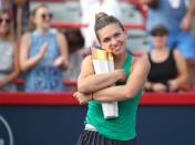 Aug 12, 2018; Montreal, Quebec, Canada; Simona Halep of Romania cuddles her trophy as she win against Sloane Stephens of the United States (not pictured) during the Rogers Cup tennis tournament at Stade IGA. Credit: Jean-Yves Ahern-USA TODAY Sports