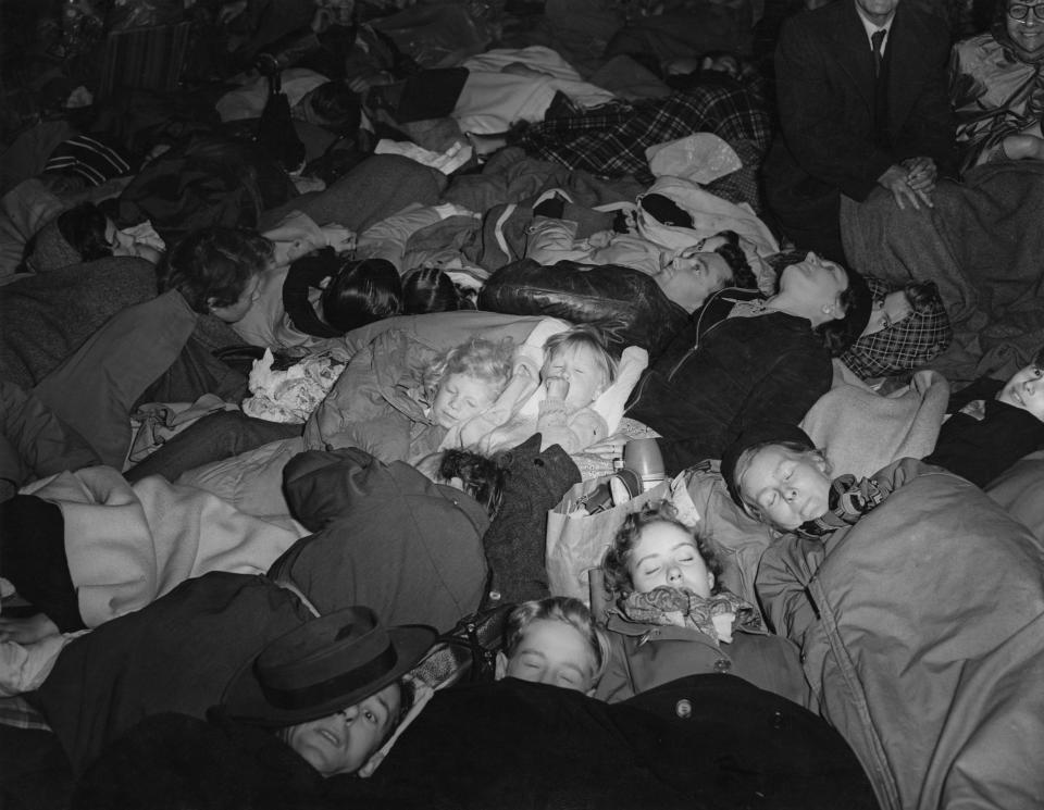 Spectators on the Coronation procession route wait through the night in London, UK on 2nd June 1953.