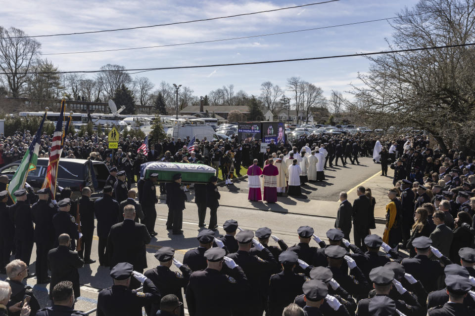 Police officers carry the casket during a funeral service for New York City Police Department officer Jonathan Diller at Saint Rose of Lima R.C Church in Massapequa Park, N.Y., on Saturday, March 30, 2024. Diller was shot dead Monday during a traffic stop. He was the first New York City police officer killed in the line of duty in two years.(AP Photo/Jeenah Moon)